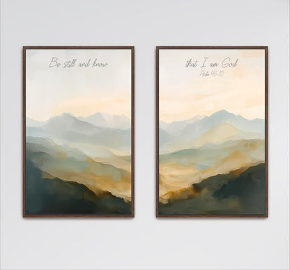 two framed paintings of a landscape with mountains in the background. The text on the paintings reads "Be still and know" and "That I am God" from the Bible verse Psalm 15:10.