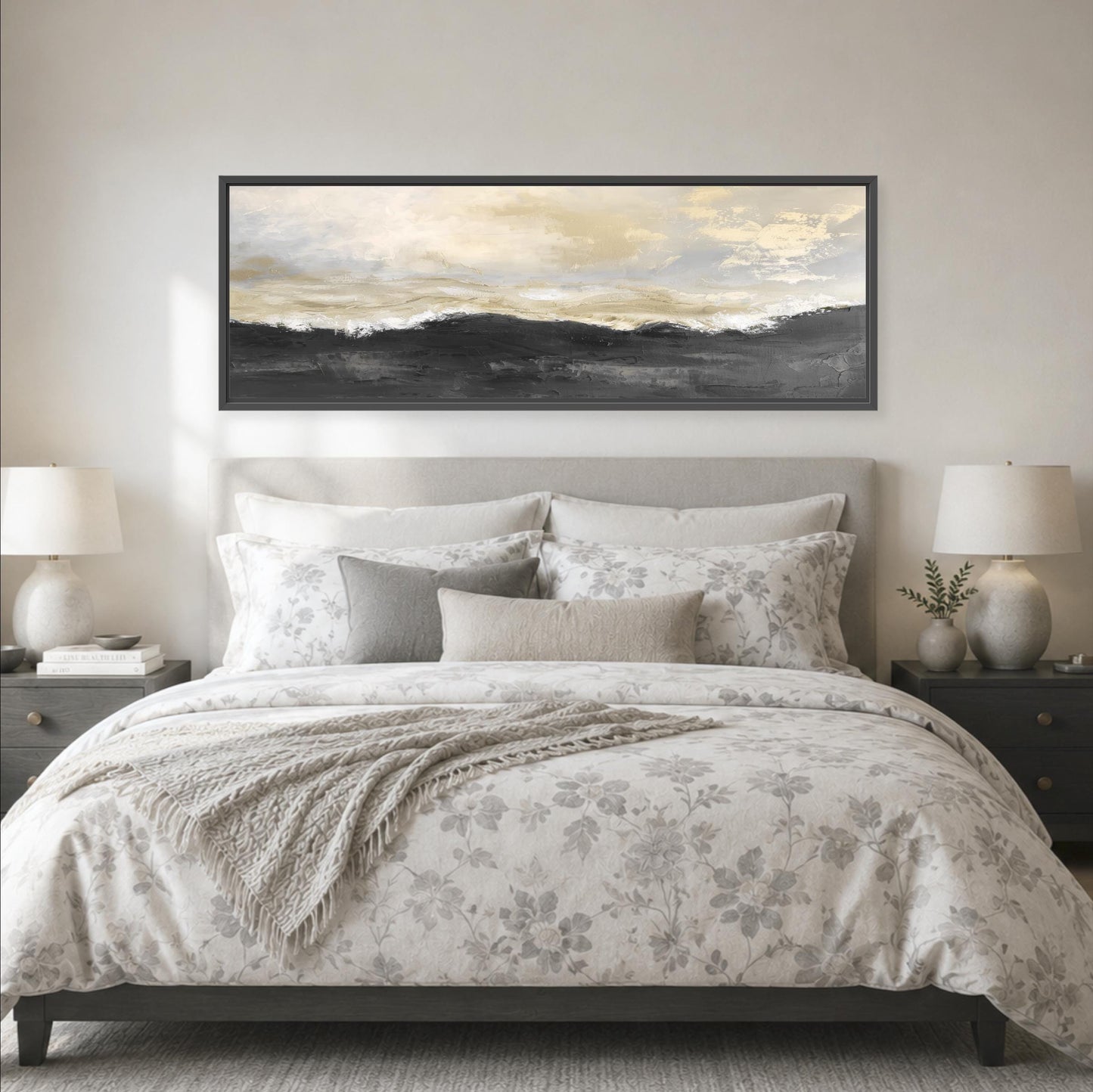 a serene bedroom scene with a large bed adorned with a floral comforter and pillows, flanked by two nightstands with lamps. Above the bed, a large framed landscape painting hangs on the wall, adding an artistic touch to the room's decor.