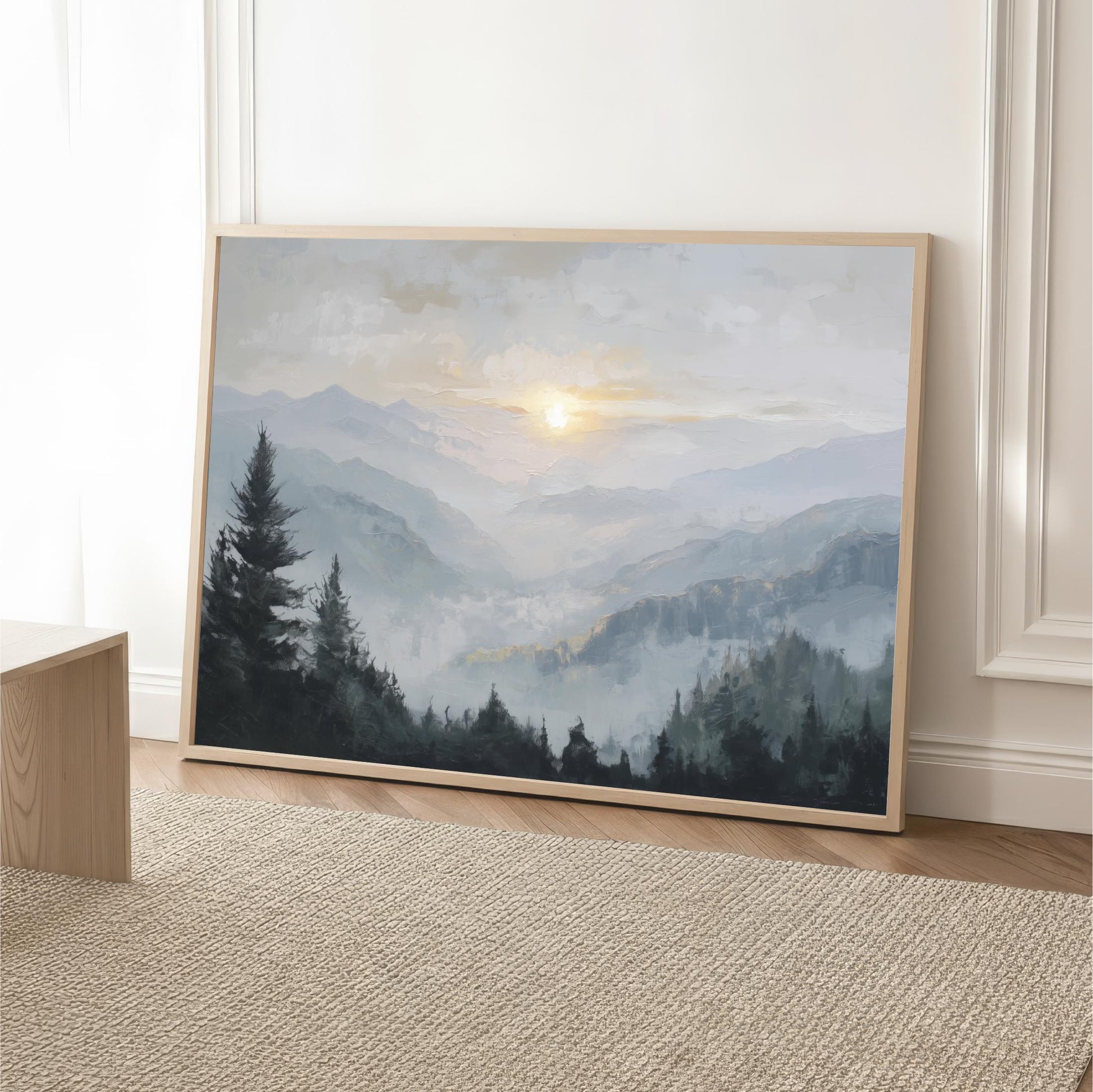 a large landscape painting depicting a mountainous, forested scene with a sunlit sky in the background.