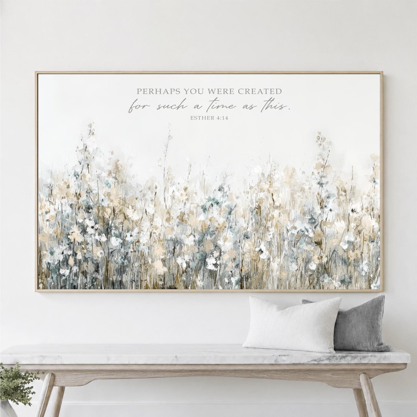 a large framed print of a field of flowers hanging on a wall above a wooden bench.