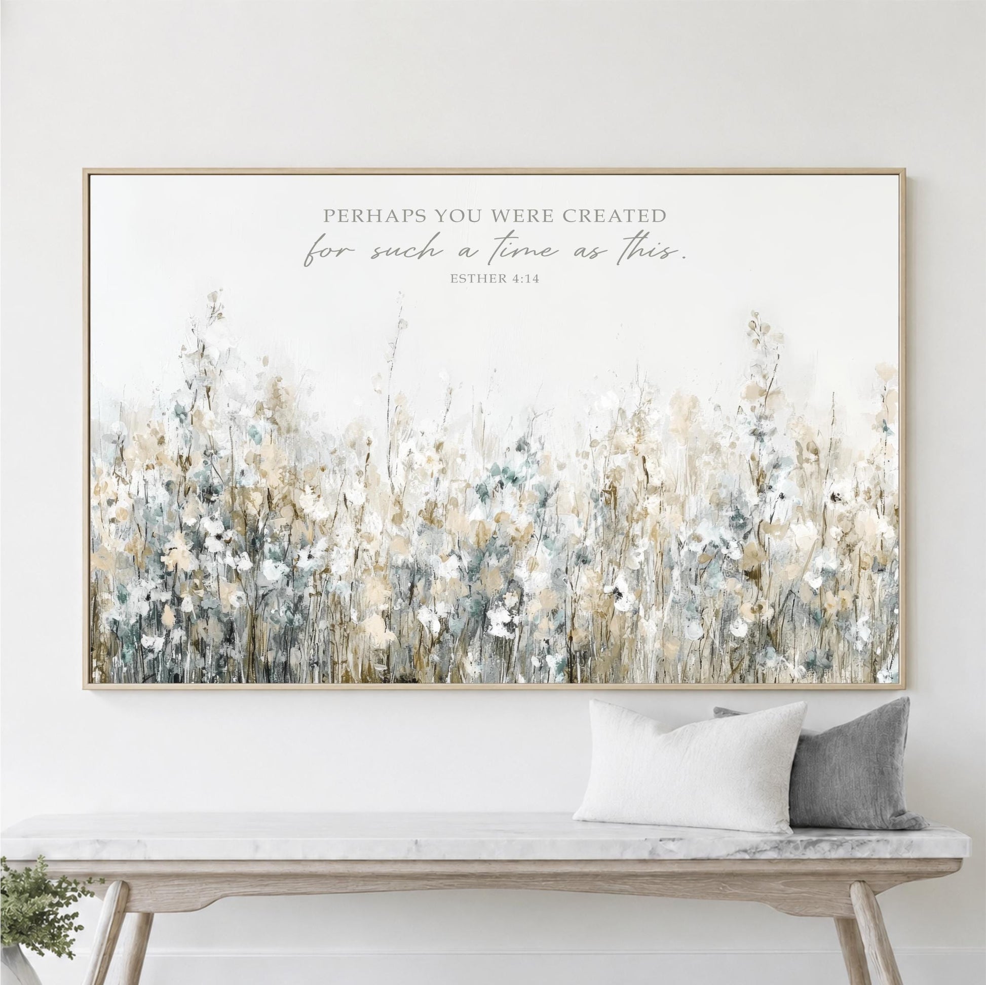 a large framed print of a field of flowers hanging on a wall above a wooden bench.
