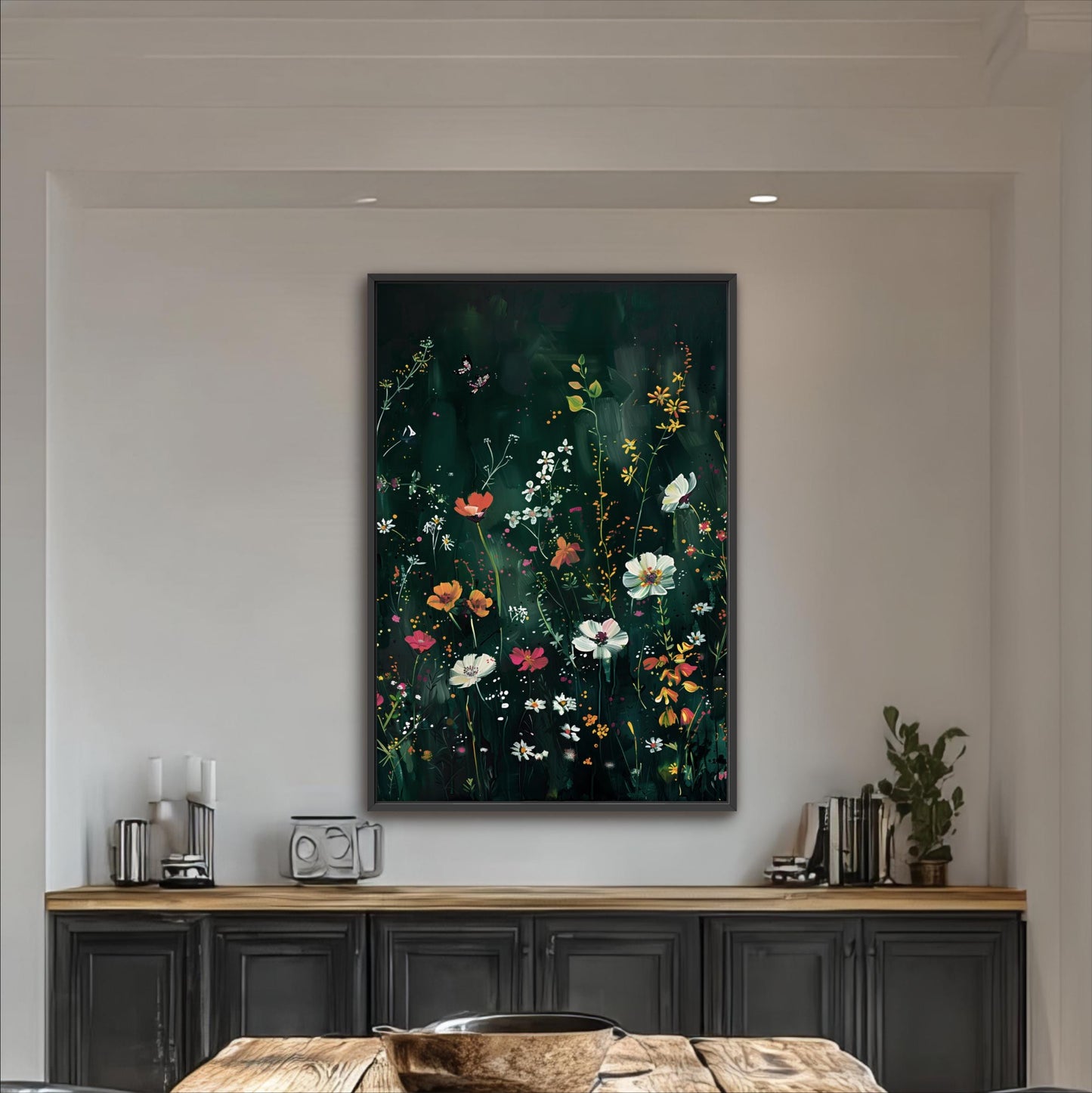 a large framed painting of a vibrant floral scene hanging on a wall above a wooden cabinet.