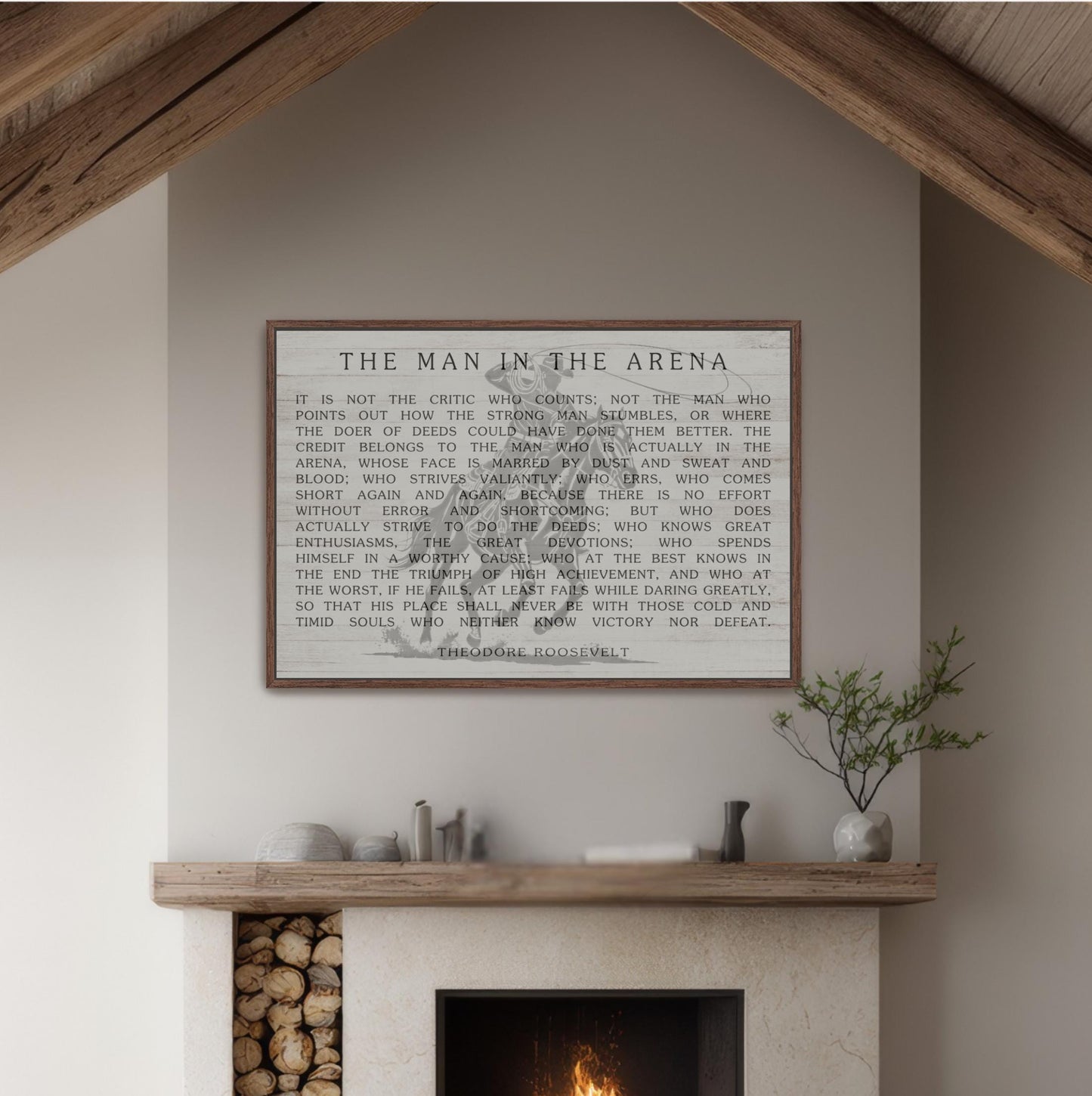 a framed quote on a wall above a fireplace, with a plant and other decorative items on the mantel below.