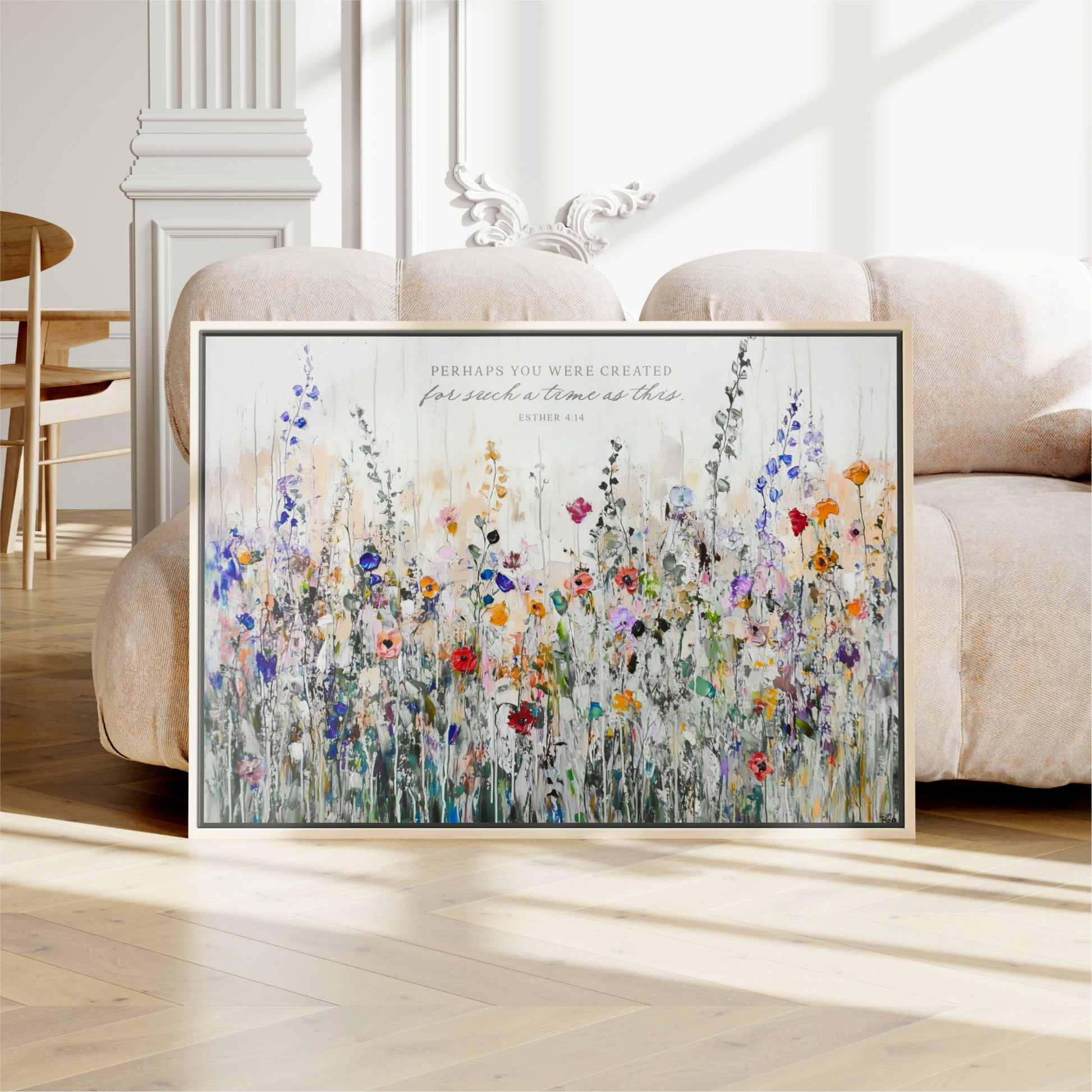 a large framed painting of a colorful field of flowers, with a quote from the Bible visible on the painting.