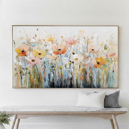 a large, colorful painting of flowers hanging on a wall above a wooden console table.