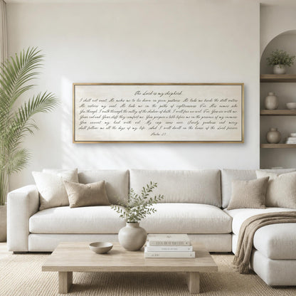 a living room with a white sofa, a wooden coffee table, and a framed Bible verse displayed on the wall above the sofa.