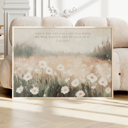 a framed painting of a field of white flowers, with a text overlay that reads "This is the day the Lord has made, we will rejoice and be Glad in it. Psalm 18:24".