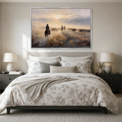 a serene bedroom scene with a large bed, a painting of cowboys on horseback, and a landscape painting above the bed.