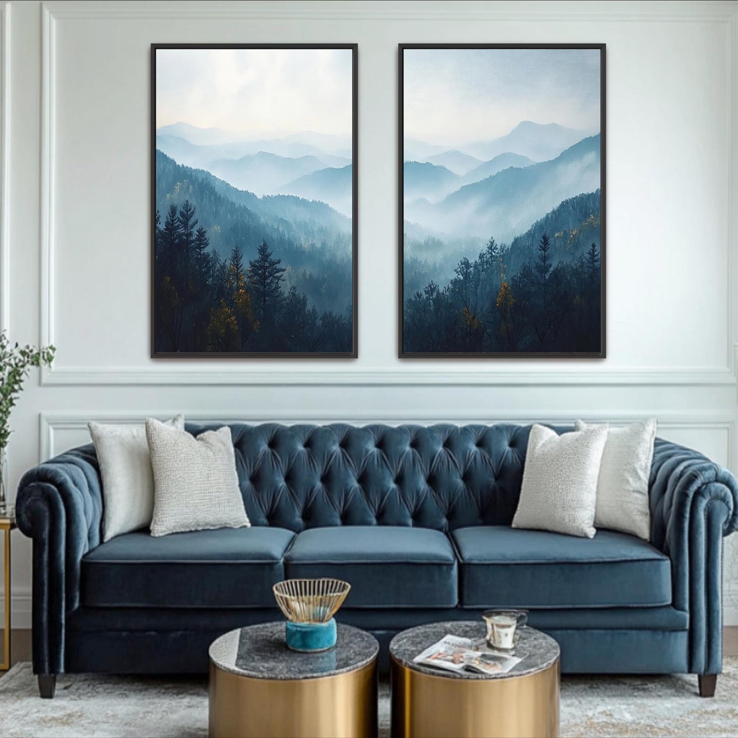a living room with a blue velvet sofa, two framed landscape paintings on the wall, and a coffee table in front of the sofa.