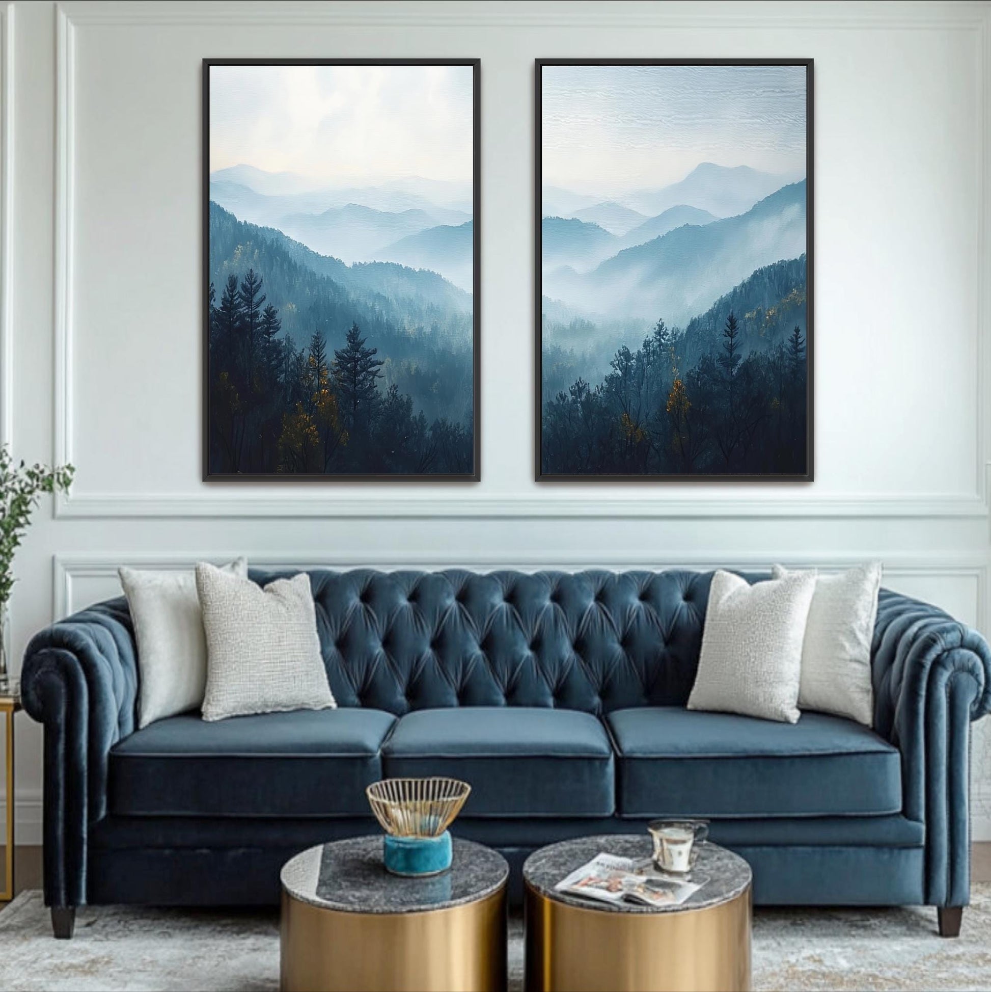a living room with a blue velvet sofa, two framed landscape paintings on the wall, and a coffee table in front of the sofa.