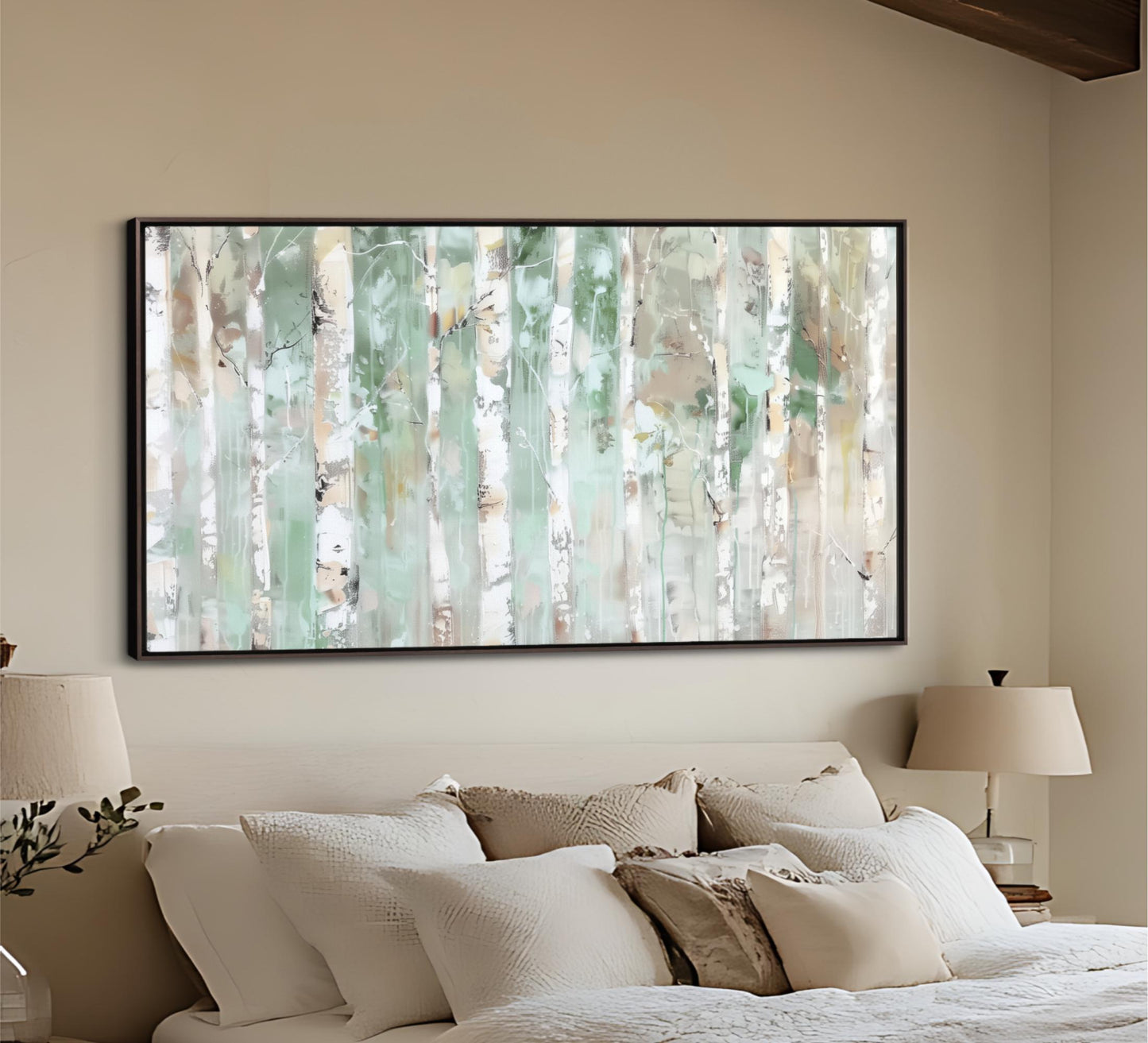 a large, framed painting of a forest scene hanging on a wall above a bed with white bedding.