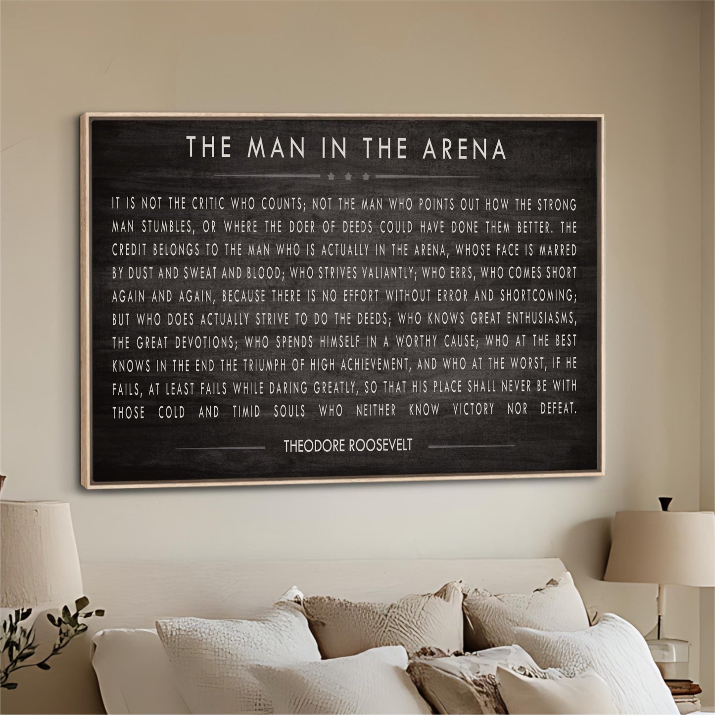 a framed quote by Theodore Roosevelt, which is displayed on a wall in a living room setting.