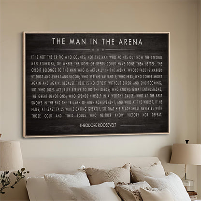 a framed quote by Theodore Roosevelt, which is displayed on a wall in a living room setting.