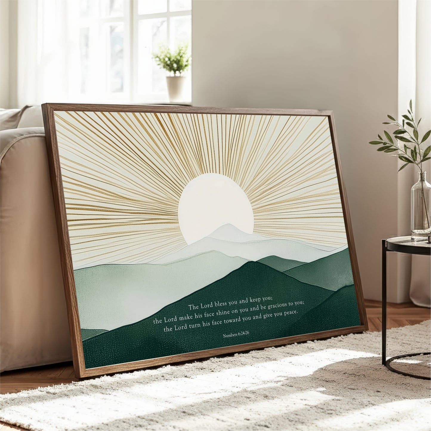 a framed print of a serene landscape with a sunburst design and mountains in the background. The text on the print reads "The Lord makes you and keep you. The Lord makes his face on you and give you peace. The Lord turns his face toward you and give you peace."