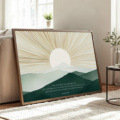 a framed print of a serene landscape with a sunburst design and mountains in the background. The text on the print reads "The Lord makes you and keep you. The Lord makes his face on you and give you peace. The Lord turns his face toward you and give you peace."