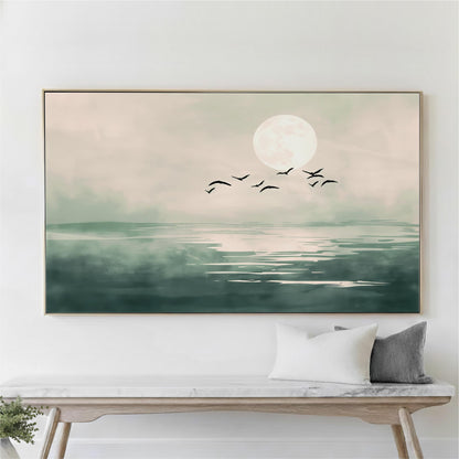 A large framed painting depicting a serene landscape with a full moon, birds flying over a body of water, and a wooden bench in the foreground.