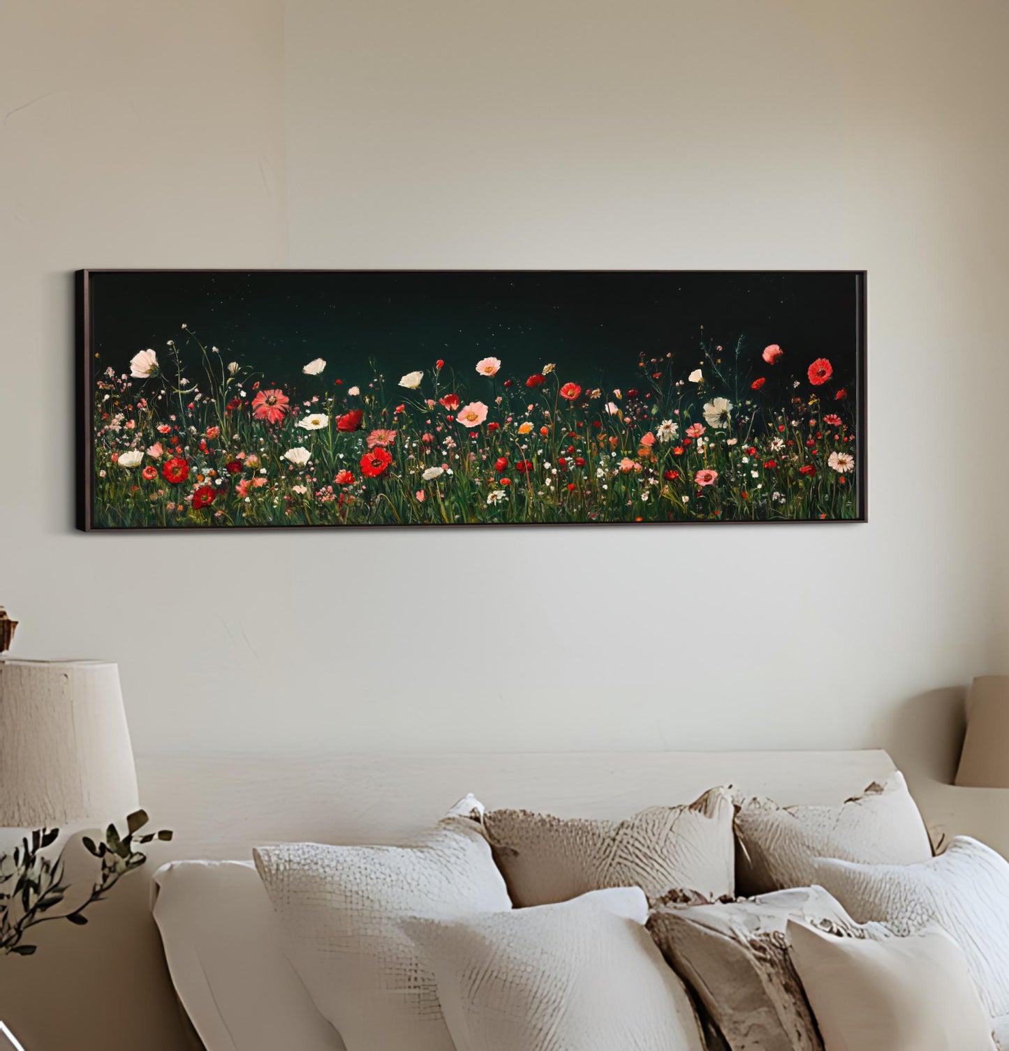 a painting of a field of flowers on a wall above a bed