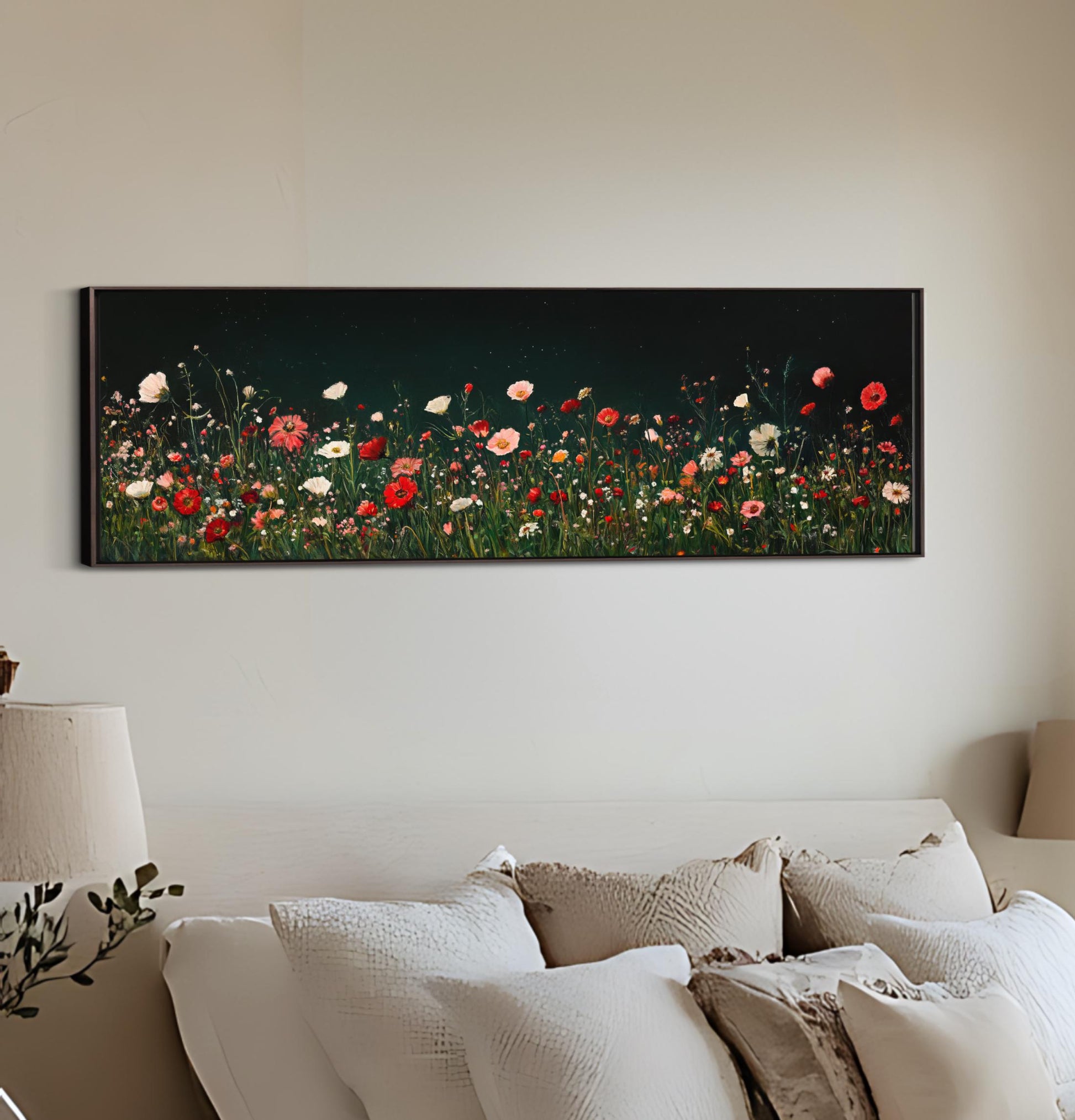 a painting of a field of flowers on a wall above a bed