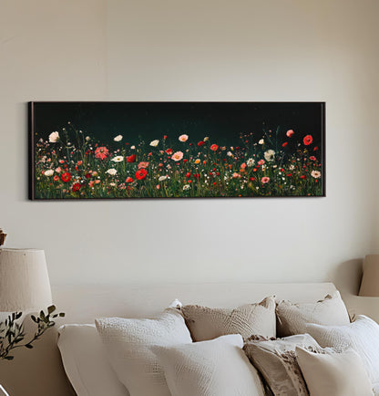 a painting of a field of flowers on a wall above a bed