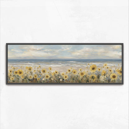 A framed painting depicting a field of yellow sunflowers overlooking a beach with the ocean in the background.