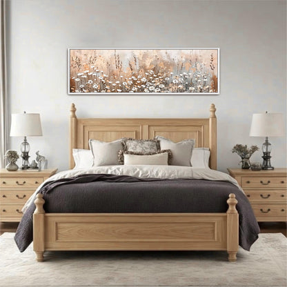 a large, wooden bed with a gray comforter and pillows, flanked by two nightstands with lamps. Above the bed is a framed painting depicting a field of flowers.