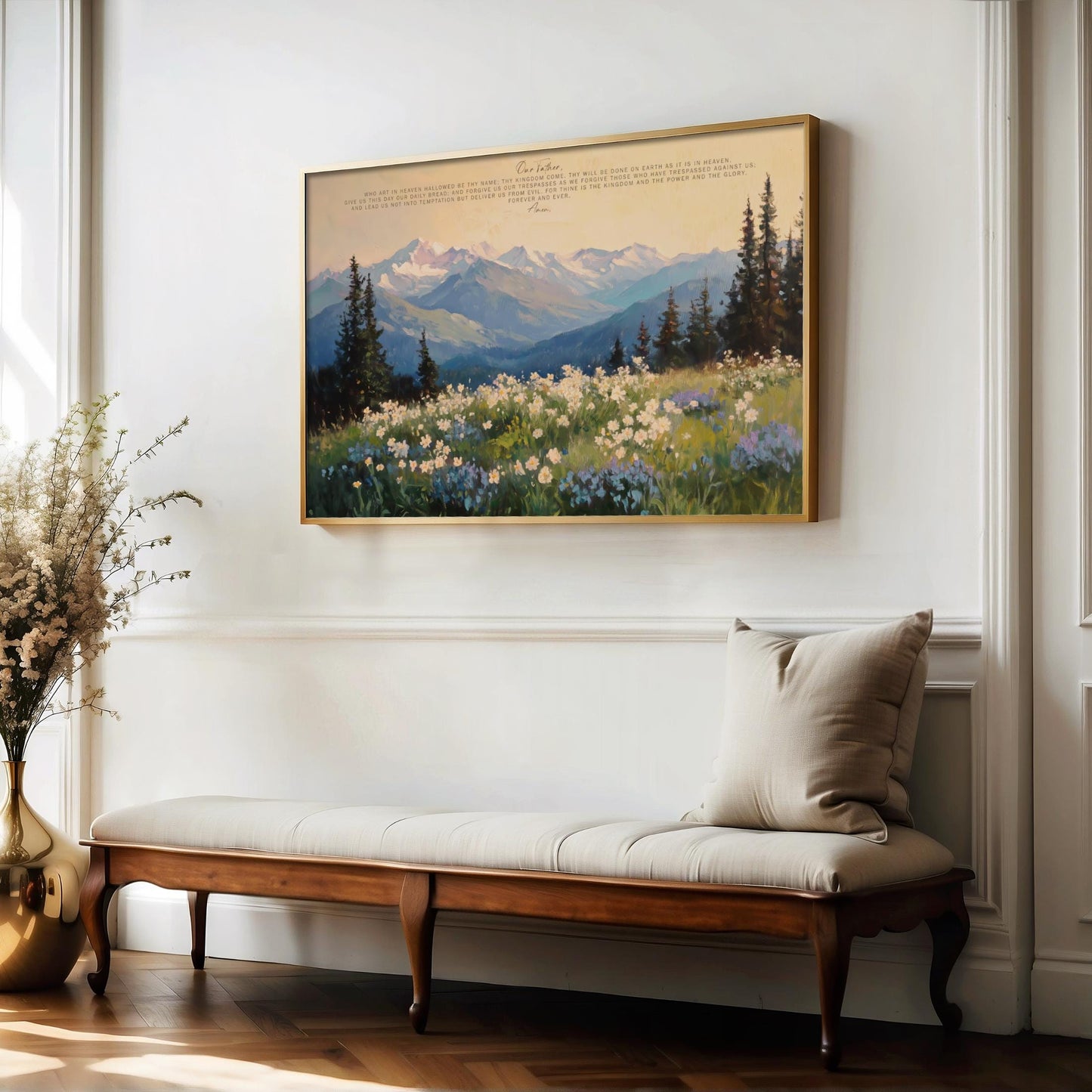 a large painting of a mountain landscape with a field of flowers, hanging on a white wall above a wooden bench with a white cushion.