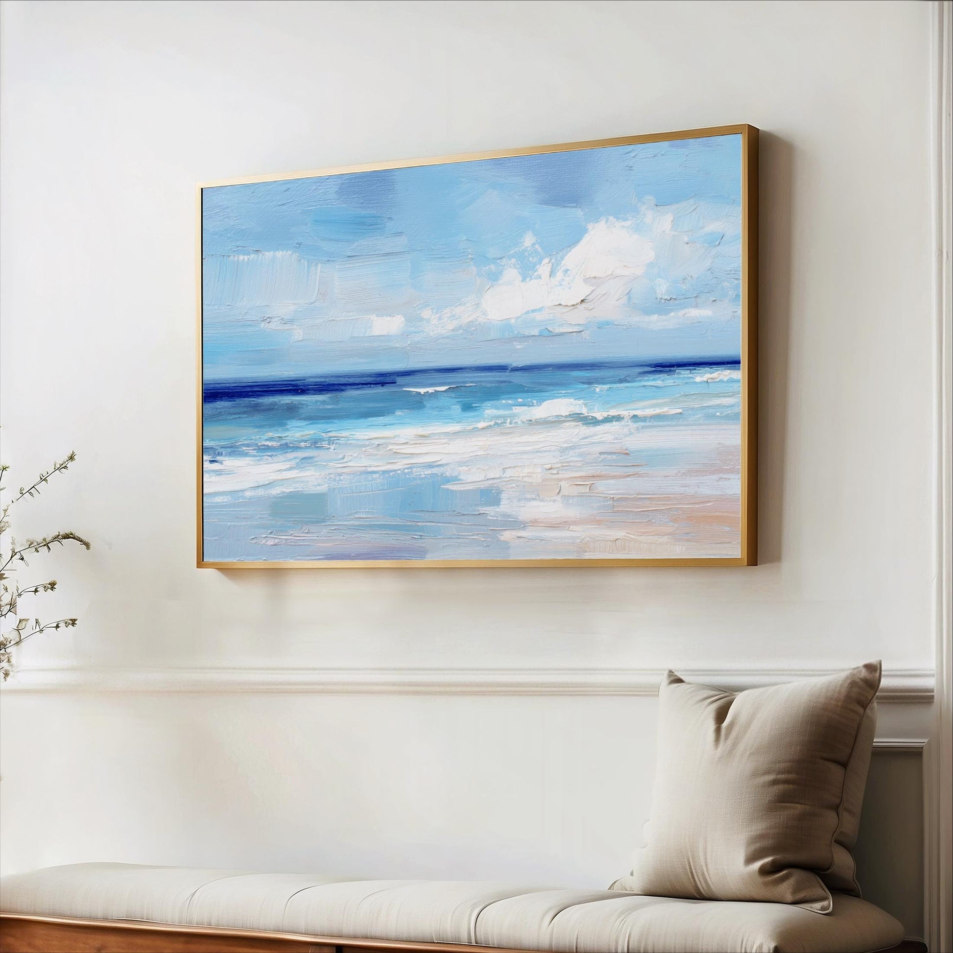 a large painting of a serene ocean scene hanging on a white wall above a wooden bench.