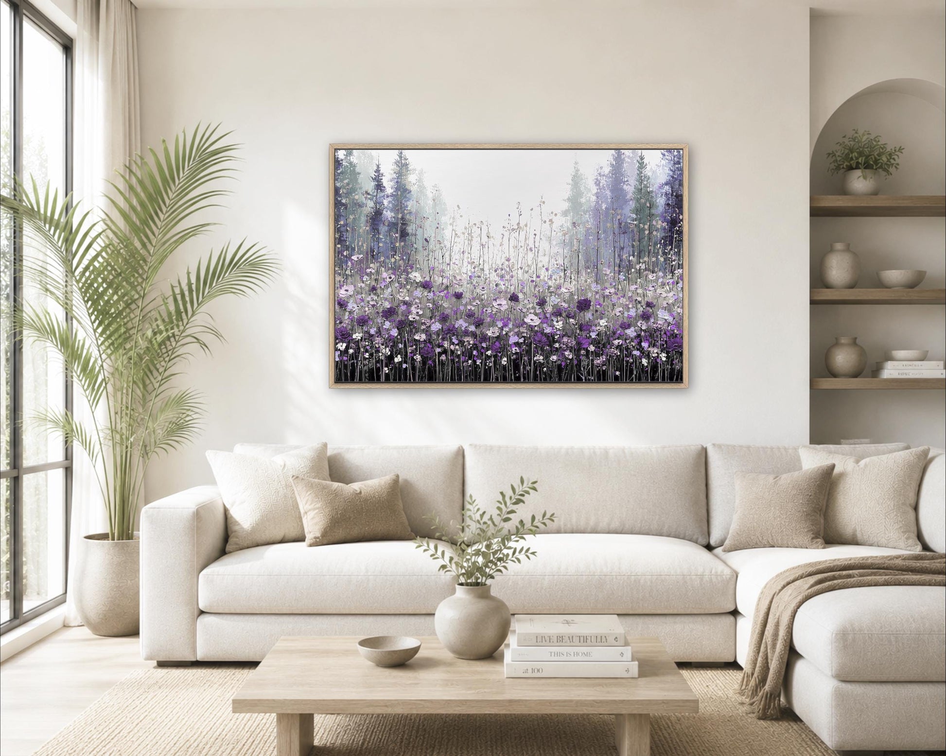 a cozy living room with a large white sofa, a wooden coffee table, and a framed painting of a field of purple flowers hanging on the wall.