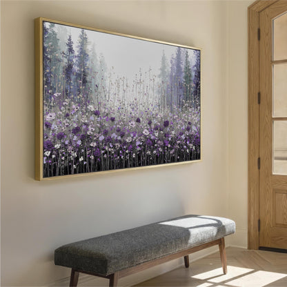 a large framed painting of a field of purple flowers hanging on a wall. Below the painting, there is a gray bench placed against the wall.