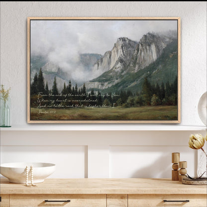 a framed painting of a mountainous landscape with a quote from Psalm 61 overlaid on the scene.