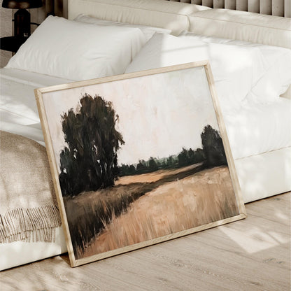 a painting of a field with trees in the background, displayed on a wooden floor next to a white bed.