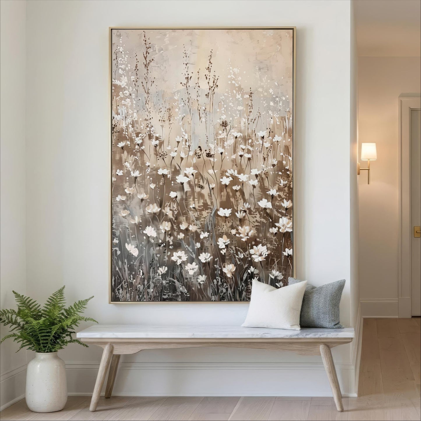 a large painting of a field of flowers hanging on a wall, with a white bench and a potted plant in the foreground.