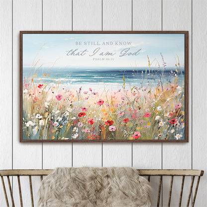 The image is a framed painting depicting a serene landscape with a field of colorful flowers and a body of water in the background.