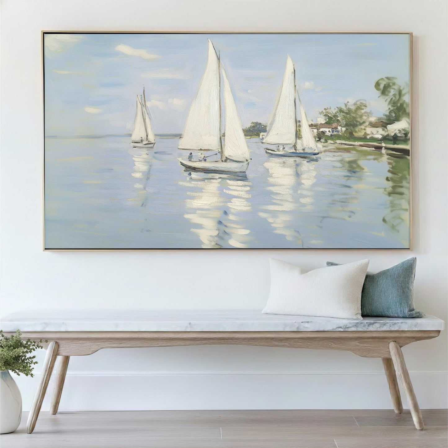 a large painting of three sailboats on the water, with a wooden bench and a green pillow in the foreground.