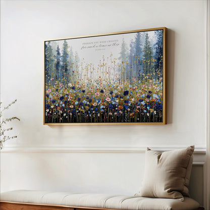 a large framed painting of a field of flowers hanging on a wall.
