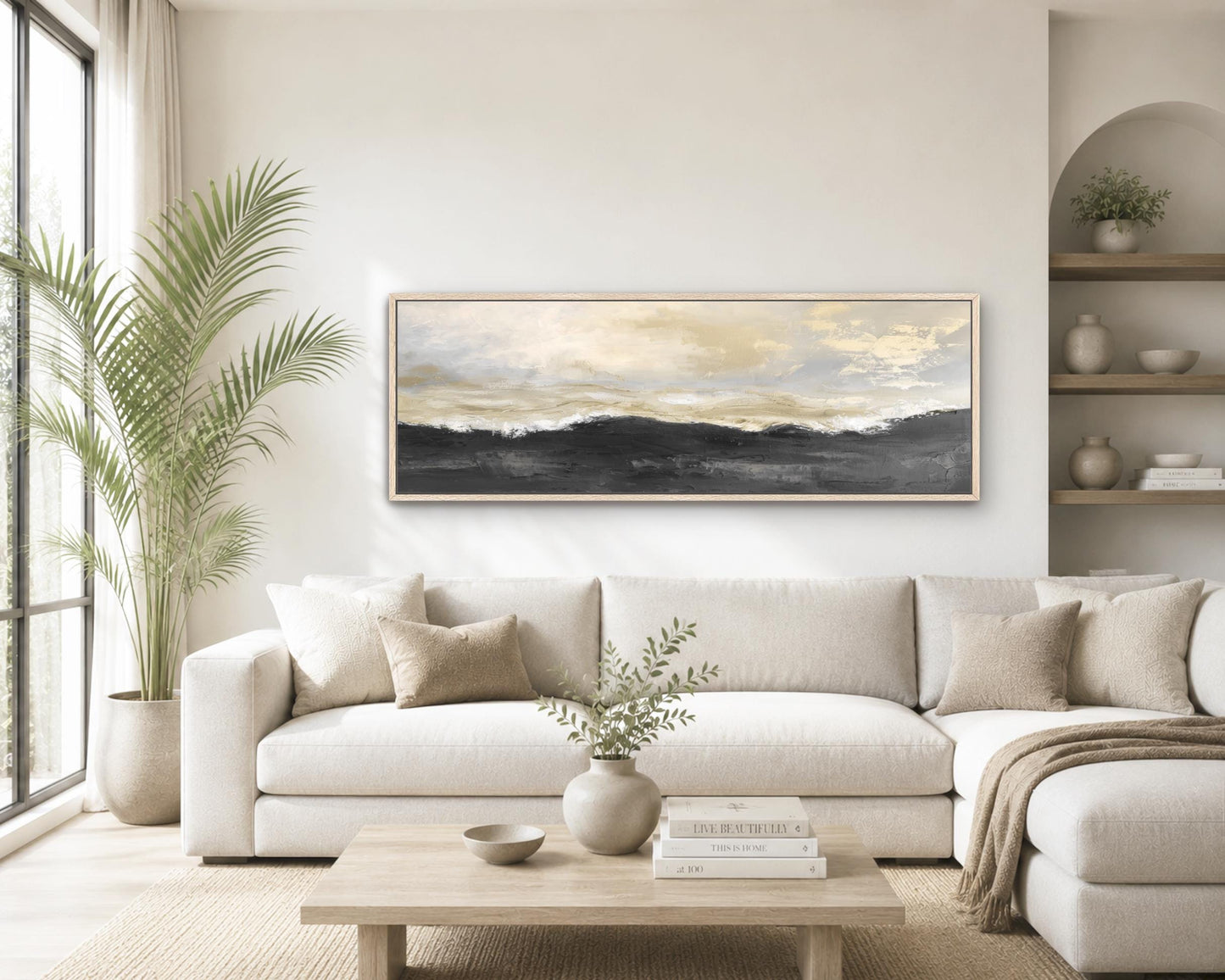 a modern living room with a large white sectional sofa, a wooden coffee table, and a large painting of a landscape hanging on the wall above the sofa.
