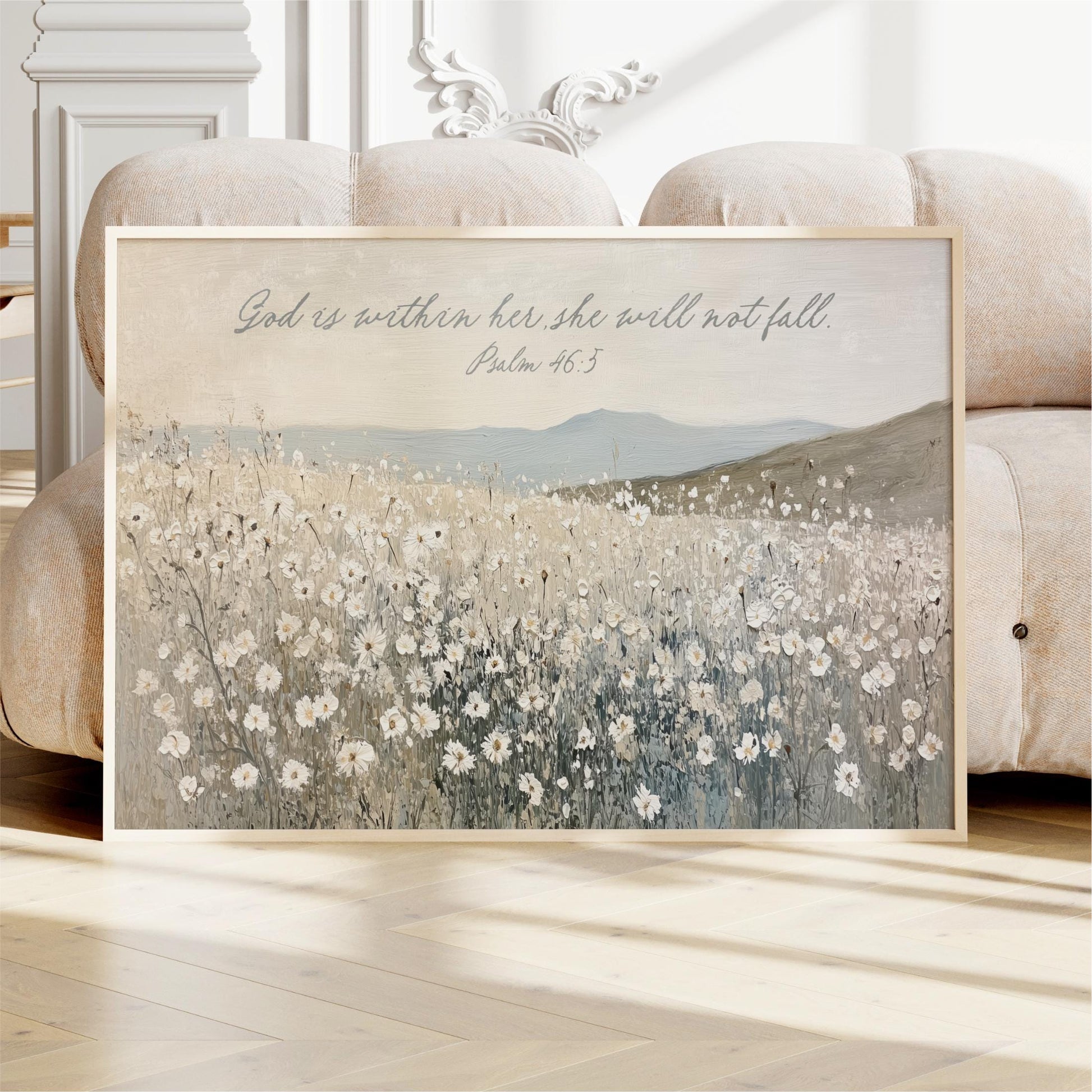 A framed painting depicting a field of white flowers, with a text overlay that reads "God is within her, she will not fall" and a Bible verse reference.