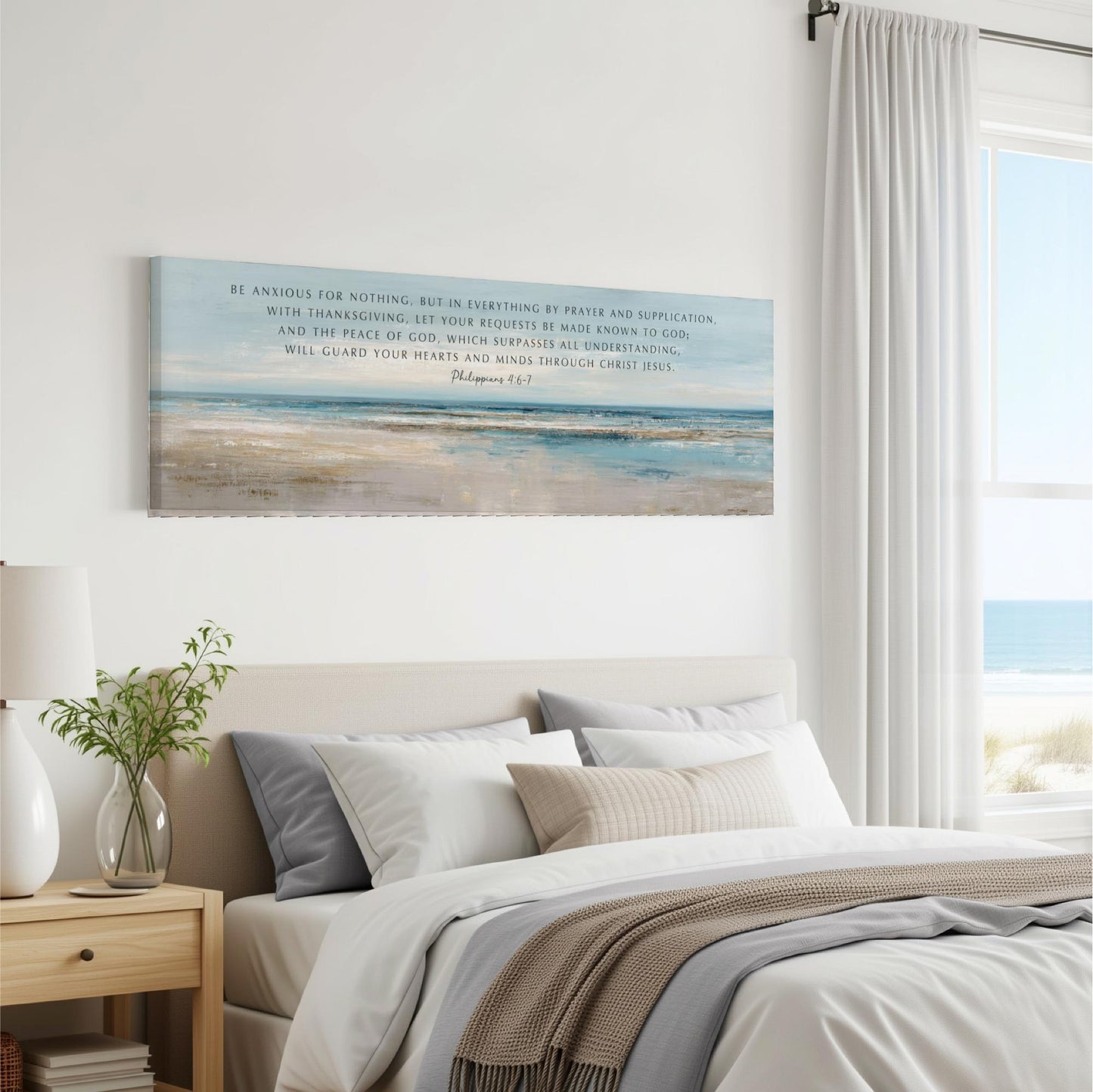 a bedroom with a large canvas print of a beach scene hanging on the wall above a bed with white bedding and a gray throw blanket.