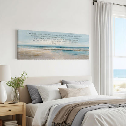 a bedroom with a large canvas print of a beach scene hanging on the wall above a bed with white bedding and a gray throw blanket.