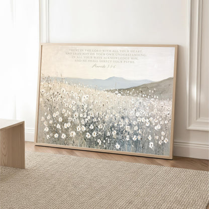 The image is a framed print of a pastoral landscape with a field of white flowers, set against a backdrop of mountains. The text on the print reads "Proverbs 3:5-6" and is located in the top right corner of the frame.