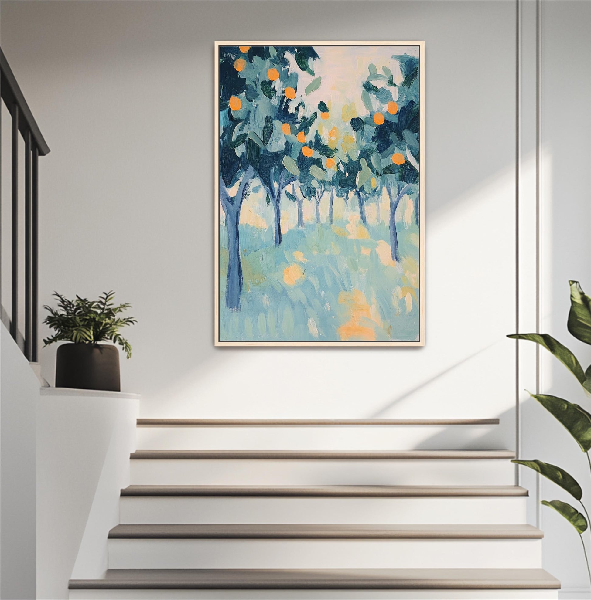a painting of a tree-filled landscape hanging on a white wall above a set of white stairs.