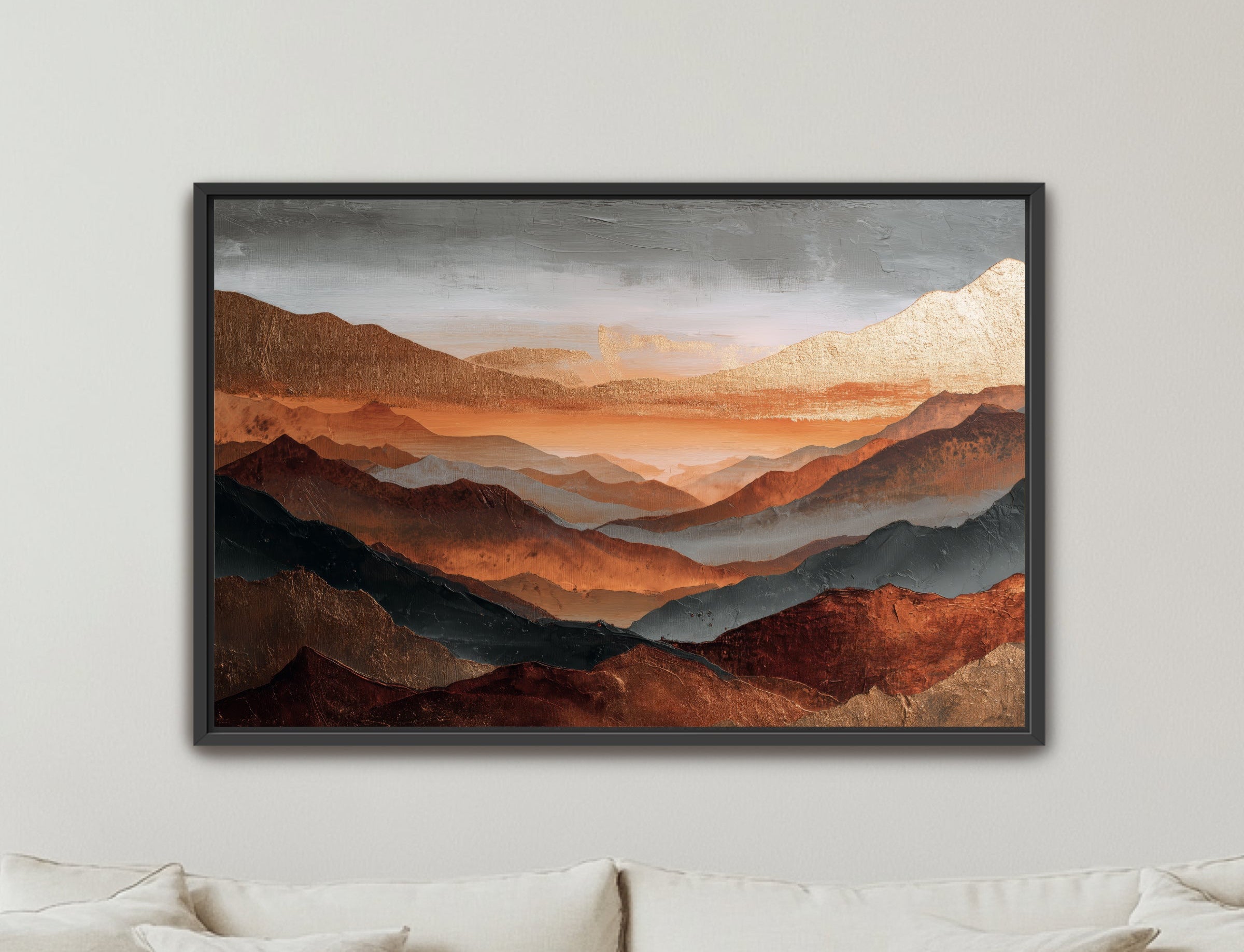 Framed mountain landscape painting on a wall above a sofa.