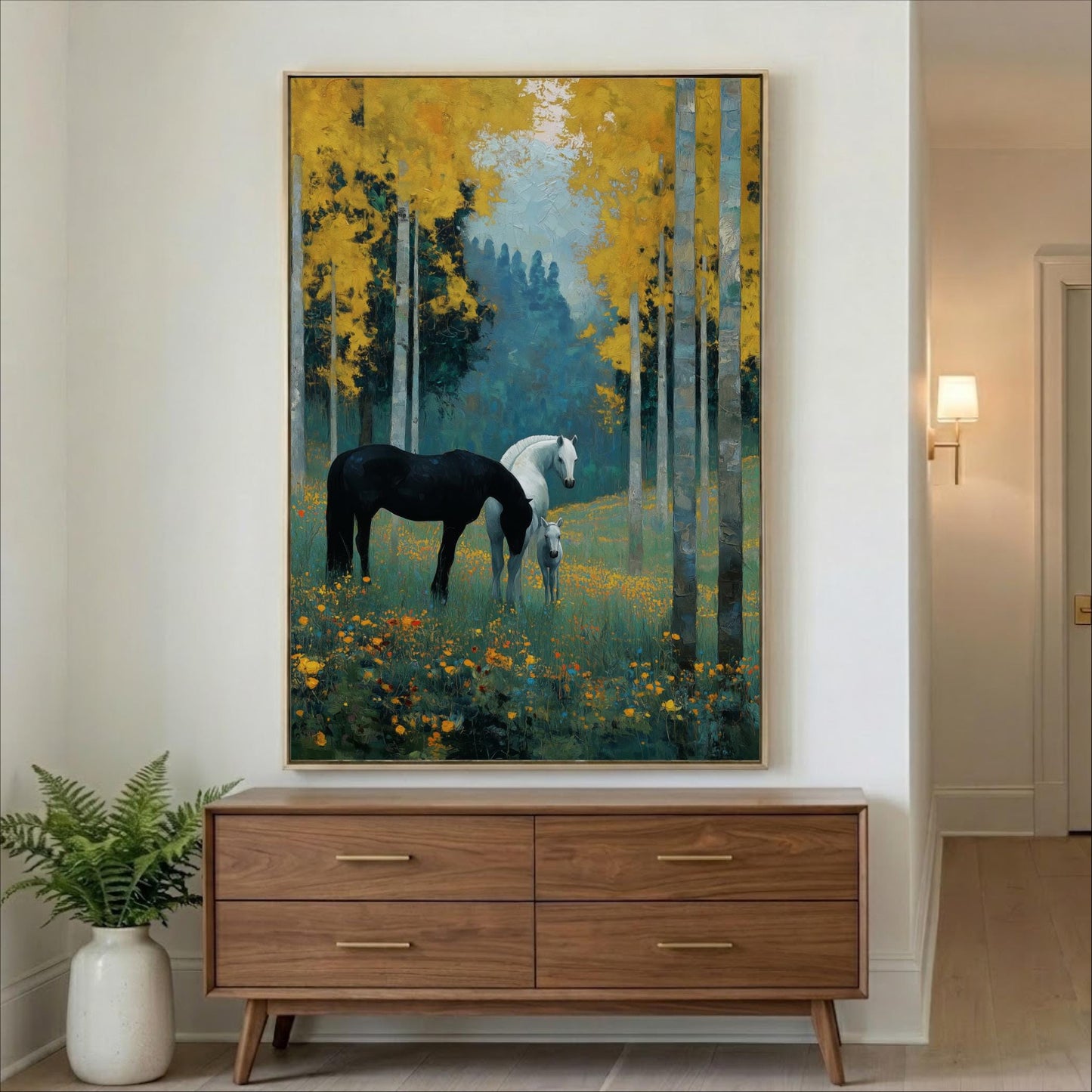 a large painting of two horses in a forest setting, with one horse being black and the other white. The painting is hanging on a wall above a wooden dresser.