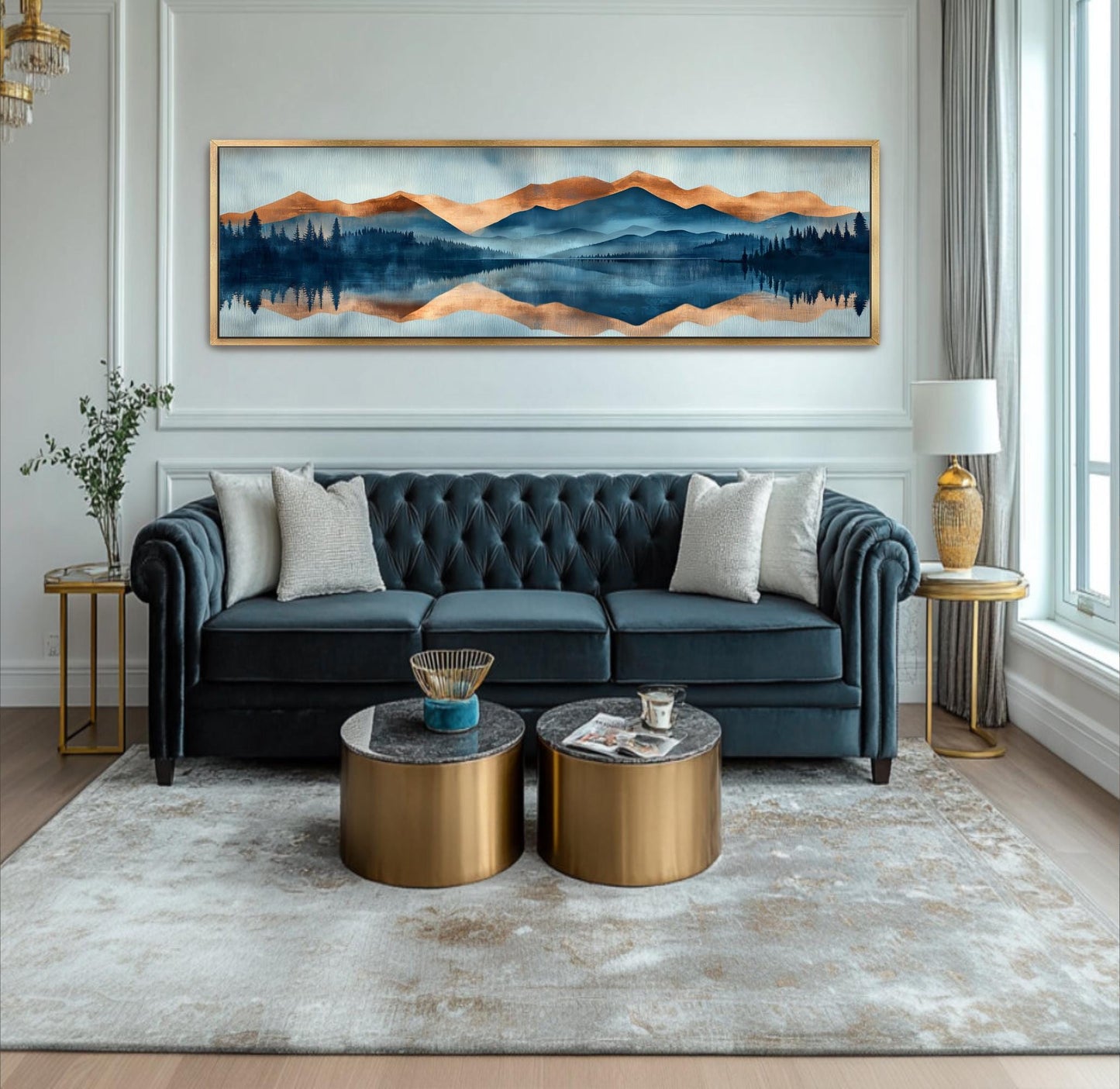 A living room with a blue tufted sofa, two round coffee tables, and a large landscape painting on the wall.