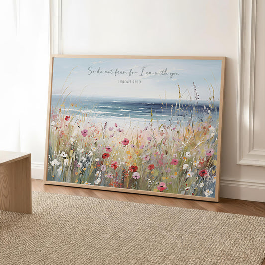 A framed painting depicting a serene landscape with a field of colorful flowers and a body of water in the background.