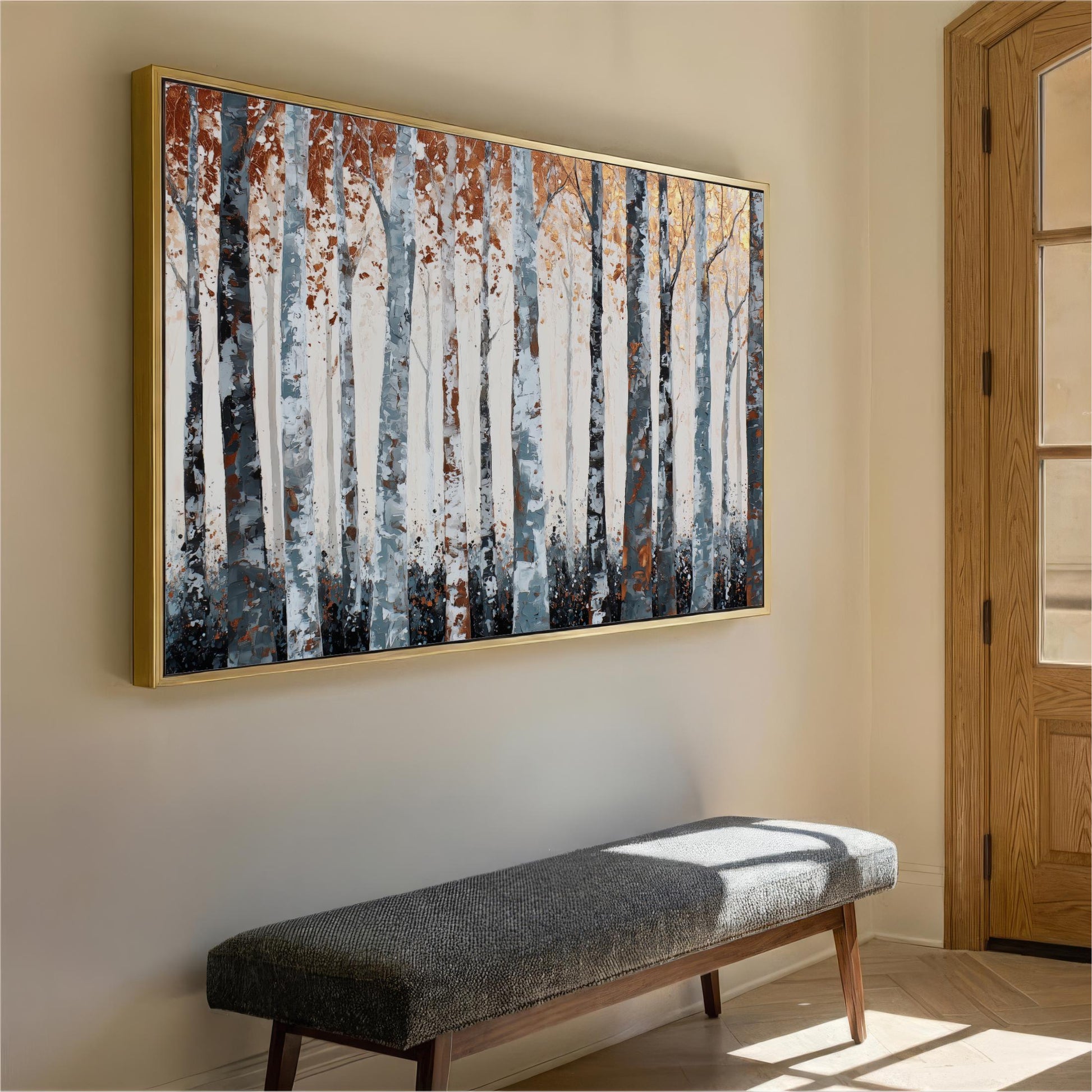 a large painting of a forest scene hanging on a wall, with a wooden bench placed in front of it.