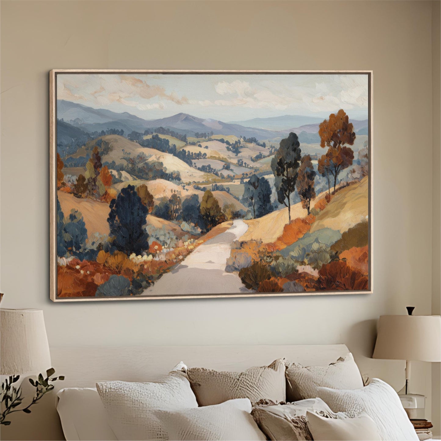 a large landscape painting hanging on a wall above a bed with white pillows.