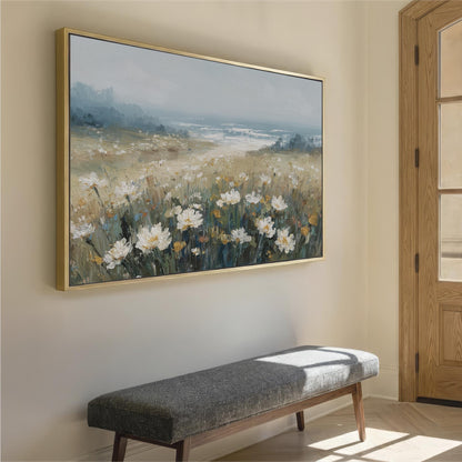 a large painting of a field of flowers hanging on a wall, with a bench placed in front of it.
