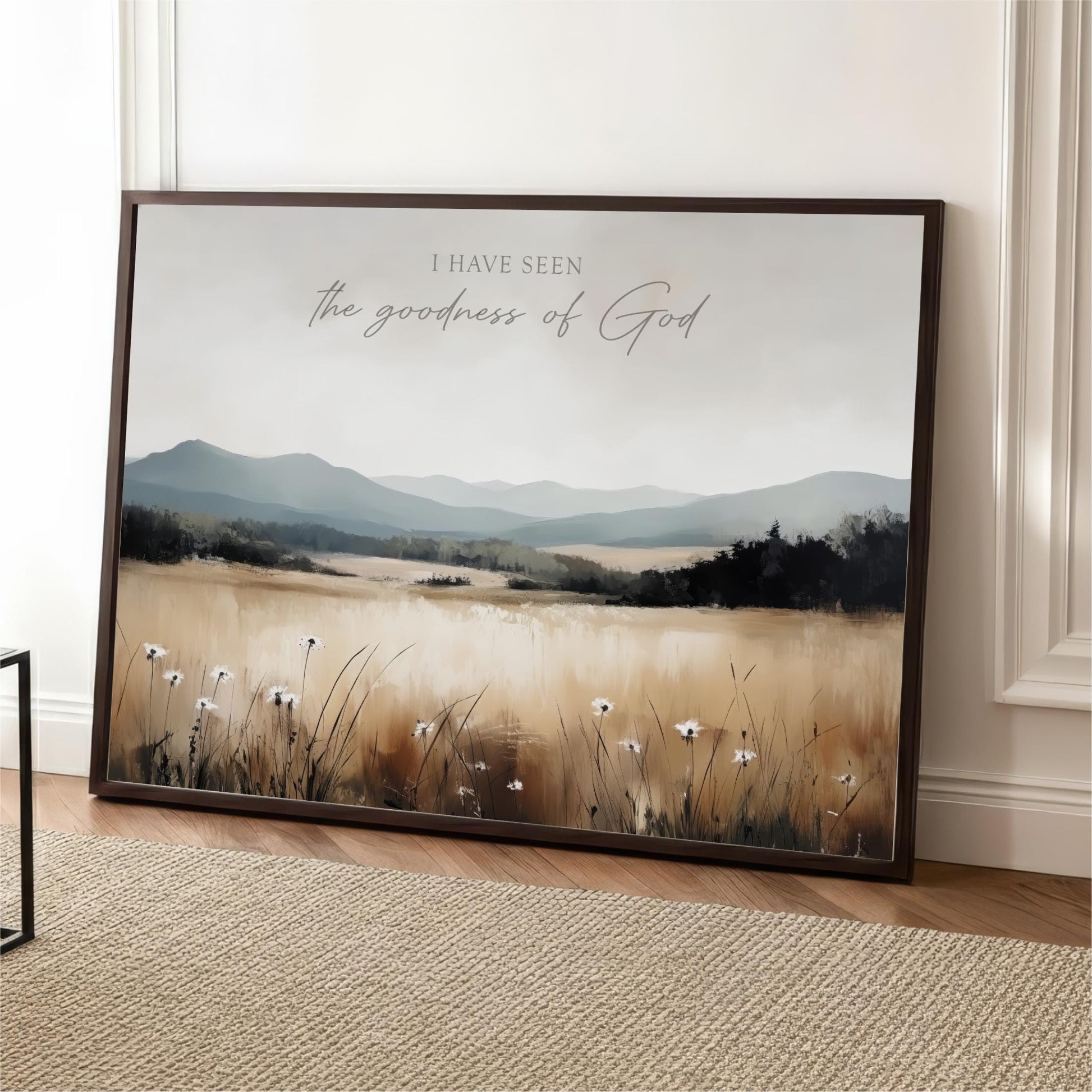 The image is a framed print depicting a serene landscape with a field of flowers and mountains in the background.
