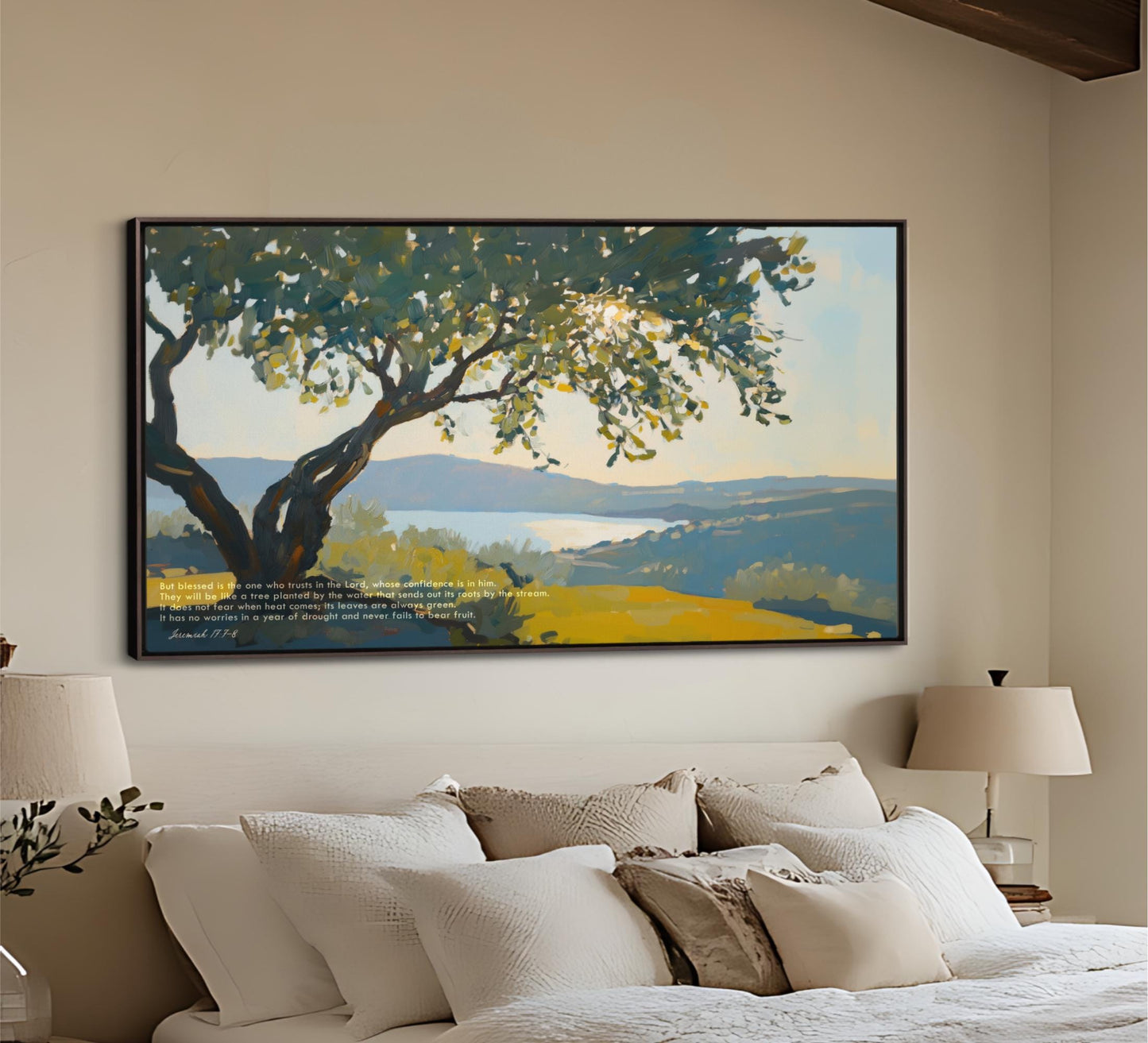 a large painting of a tree with a blue sky and mountains in the background, hanging on a wall above a bed with white pillows and a beige headboard.